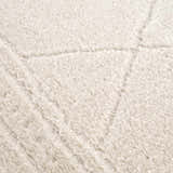 Close-up of the ivory Keone rug, showing its plush texture and subtle geometric pattern. Texture