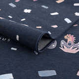 Close-up of the Milne Navy Dinosaur Washable Kids Rug, featuring a playful dinosaur pattern and a durable, textured weave. Fold