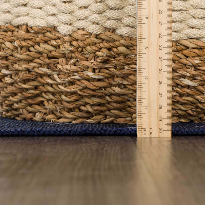 Close-up of the Milne Navy Dinosaur Washable Kids Rug showing texture and thickness with ruler for scale. Pile