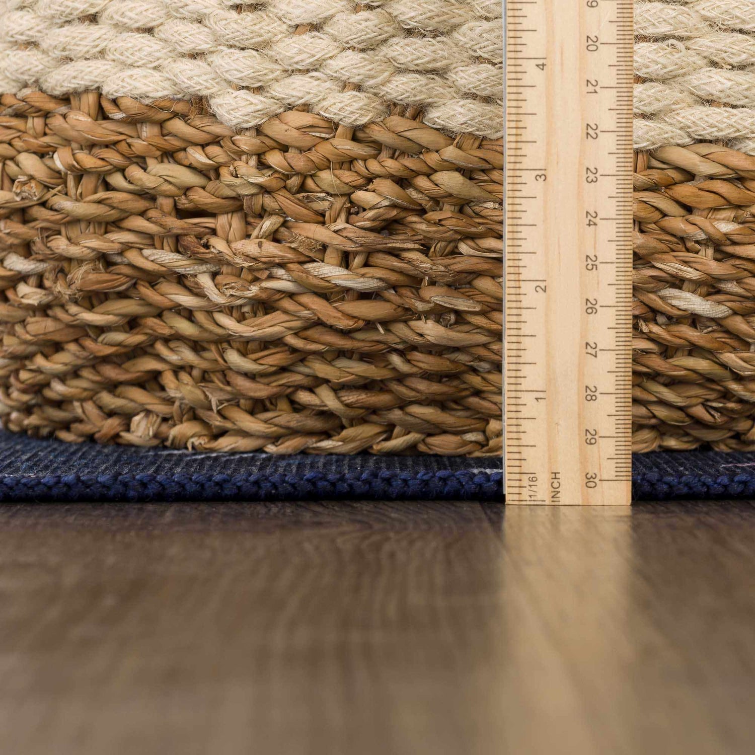 Close-up of the Milne Navy Dinosaur Washable Kids Rug showing texture and thickness with ruler for scale. Pile