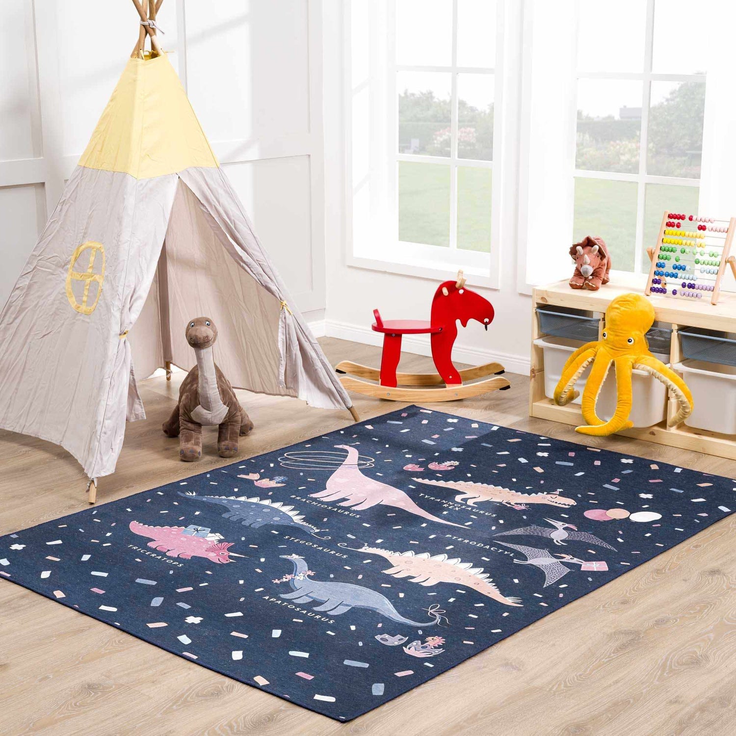 Kids playroom with Milne Navy Dinosaur Washable Kids Rug, teepee tent, rocking horse, and toys. Roomscene-Rectangle