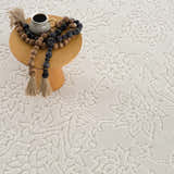 Close-up of the Off White Senekal 3D Outdoor Area Rug with a subtle geometric pattern and a textured, soft pile. Styleshot