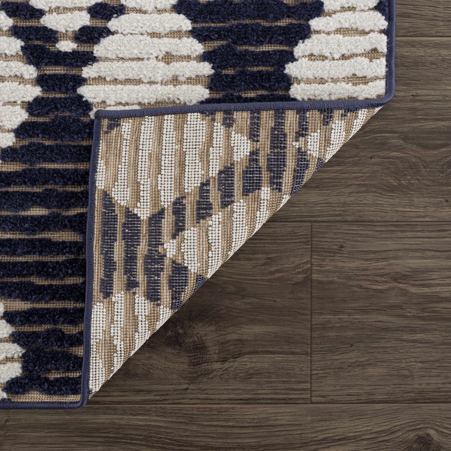 Close-up of the Enhaut 3D Outdoor Area Rug showing bone, cloud gray, and light gray geometric pattern and rug backing. Fold