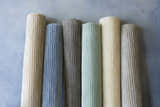 Rolled Ahmeek Area Rugs in gray, blue, green, and beige. Viscose rugs with subtle stripe pattern. Styleshot