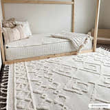 Kids room with a light wood bed and the bone-colored geometric Gyundyukoru Area Rug with tassels. Roomscene-Rectangle