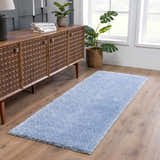 Entryway with Faina Solid Aqua Shag Washable Area Rug runner, wood cabinet, plants, and wood floors. Roomscene-Runner