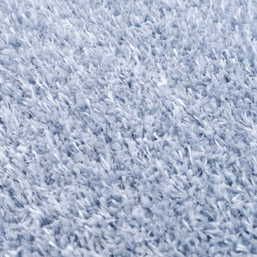 Close-up of the plush texture of the Faina Solid Aqua Shag Washable Area Rug, showing its soft, dense pile. Texture