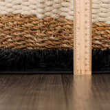 Close-up of the Faina Solid Black Shag Washable Area Rug showing the texture and pile height with a ruler. Pile