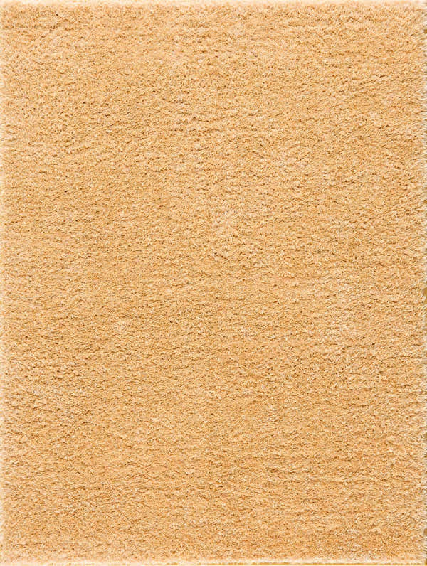 Close-up of the plush texture of the Faina Solid Gold Shag Washable Area Rug. Soft, golden, and inviting. Design-Rectangle-46