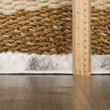 Close-up of the shag Lotta Area Rug showing gray and white fibers next to a basket and a ruler. Pile