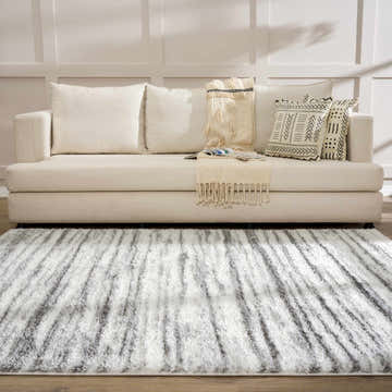 Living room scene with a cream sofa and the gray and white Lotta Area Rug. Roomscene-Rectangle