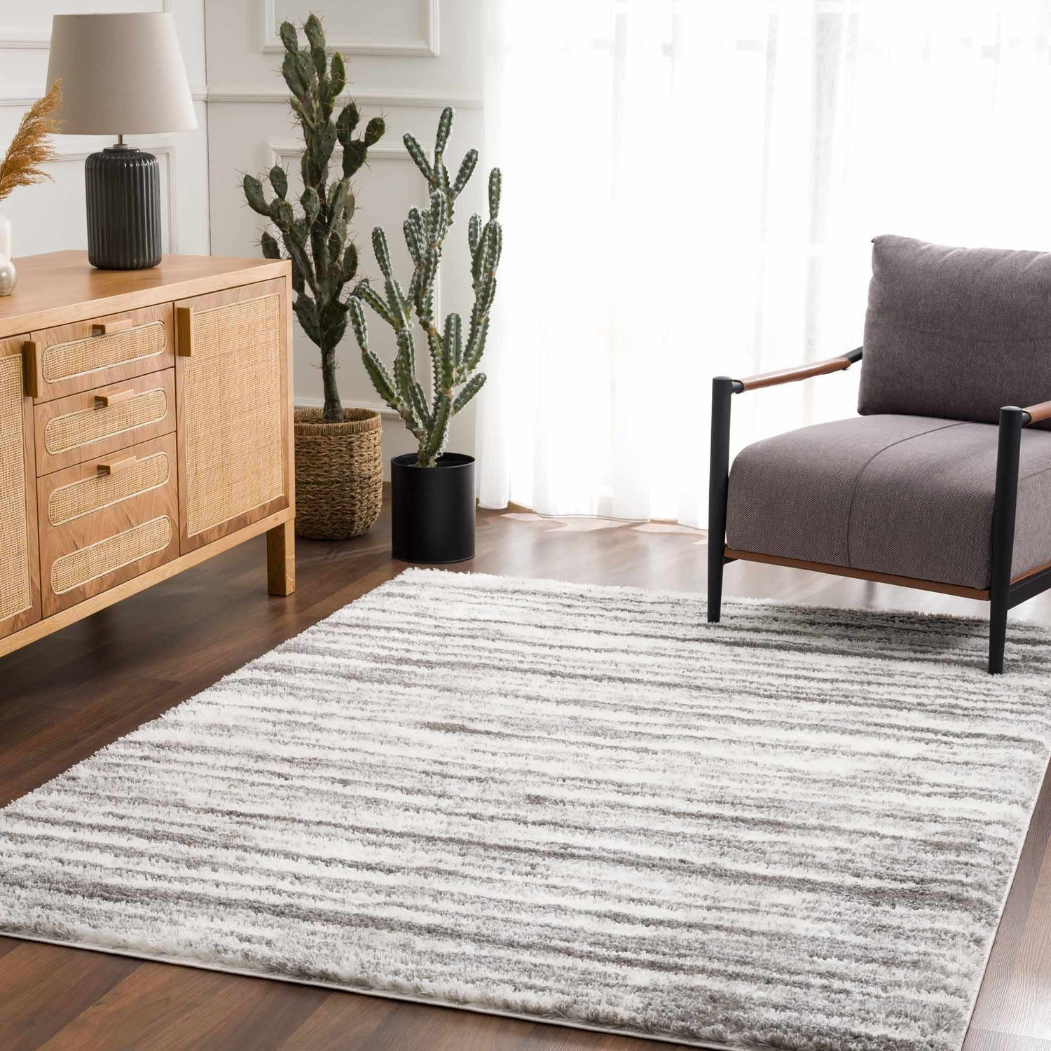 Living room scene with a gray chair and the gray and white Lotta Area Rug. Roomscene-Rectangle