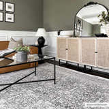 Living room with gray walls, brown sofa, and Hedda Boutique Washable Rug in dark gray. Farmhouse style with modern black accents. Roomscene-Rectangle