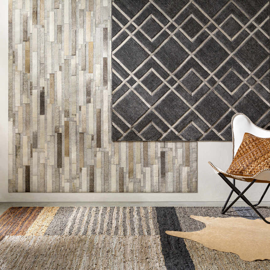 Taclobo Area Rug in a styled room with a modern chair, geometric wall art, and neutral tones. Styleshot