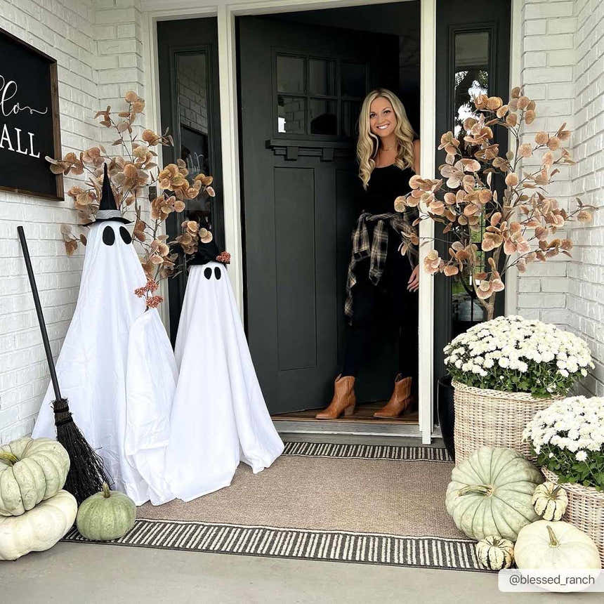 Festive front porch with ghosts, pumpkins, and Kidron Area Rug in beige and black. Halloween decor. Roomscene-Rectangle