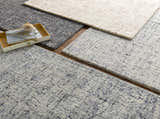 Close-up of Tanana Area Rug in black, cream, and gray wool. Hand-tufted contemporary design with subtle texture. Styleshot