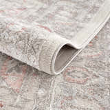 Close-up of the plush Damla Area Rug, showcasing its gray and pink vintage design and machine-woven texture. Fold