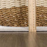 Close-up of the Damla Area Rug showing the gray and beige braided texture and pile height with a ruler. Pile