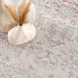 Close-up of the Damla Area Rug, a machine-woven rug in gray and pink with a traditional, vintage-inspired pattern. Soft texture. Styleshot