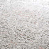 Close-up of the Damla Area Rug, a machine woven rug with a gray and pink vintage floral pattern. Soft texture. Texture