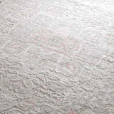 Close-up of the Damla Area Rug with a traditional gray and pink floral pattern and soft, textured pile. Texture