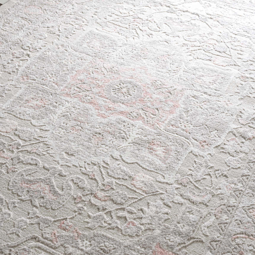 Close-up of the Damla Area Rug with a traditional gray and pink floral pattern and soft, textured pile. Texture