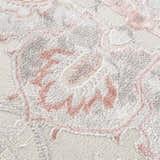 Close-up of the Calum Pink Floral Area Rug showing the texture and floral pattern in gray and pink. Texture