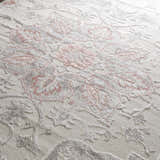 Close-up of the Calum Pink Floral Area Rug showing its texture and gray and pink traditional floral design. Texture