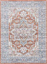 Close-up of Ember Washable Area Rug in beachhouse, charcoal, and copper. Traditional style with a detailed, symmetrical pattern. Design-Rectangle-5373