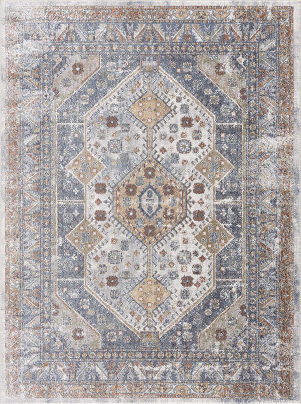 Close-up of the Afya Boutique Washable Rug. Traditional style rug in beige, blue, rust, and tan with a distressed geometric pattern. Design-Rectangle-5373