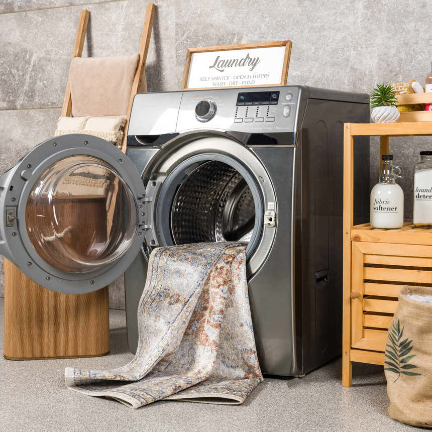 Laundry room scene with Emke Flat Pile Washable Rug partially inside a washing machine. Farmhouse style decor. Washing-Machine