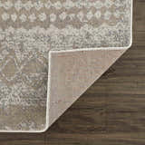 Close-up of Tupsan Washable Area Rug showing cream, beige, and gray colors with a subtle geometric pattern and woven texture. Fold