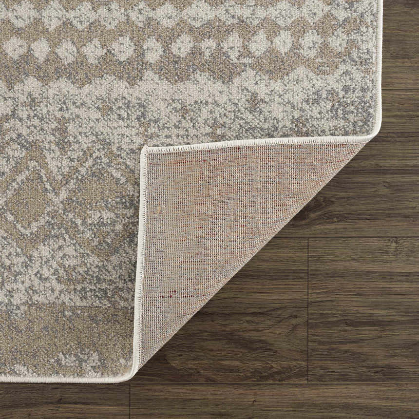 Close-up of Tupsan Washable Area Rug showing cream, beige, and gray colors with a subtle geometric pattern and woven texture. Fold