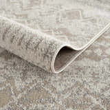 Close-up of Tupsan Washable Area Rug showing its cream, beige, and gray contemporary pattern and machine-woven construction. Fold