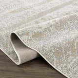 Close-up of the Tupsan Washable Area Rug showing its cream, light beige, and light gray contemporary pattern and soft texture. Fold