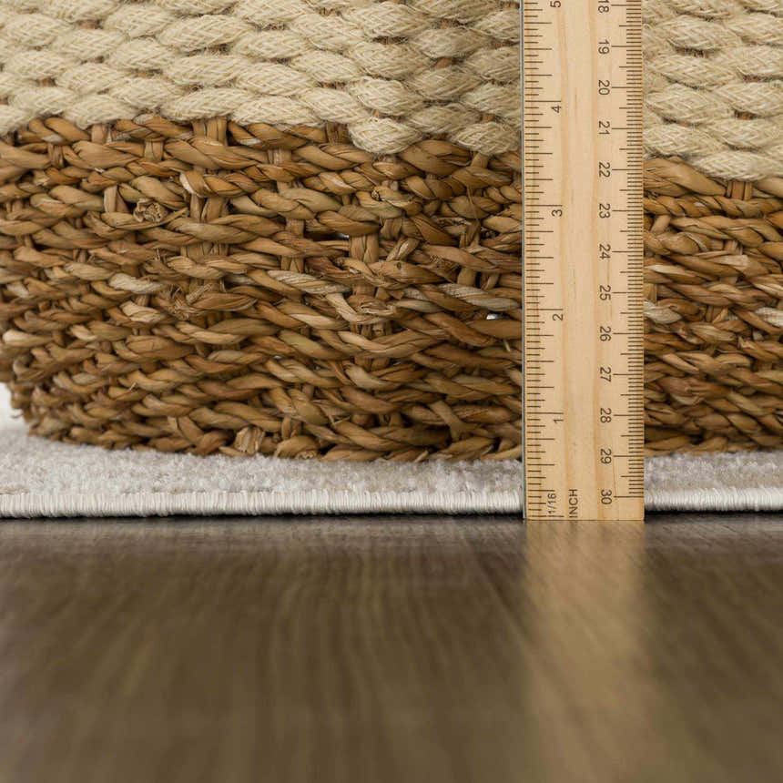 Close-up of Tupsan Washable Area Rug showing the cream color, soft texture, and rug thickness with a ruler. Pile