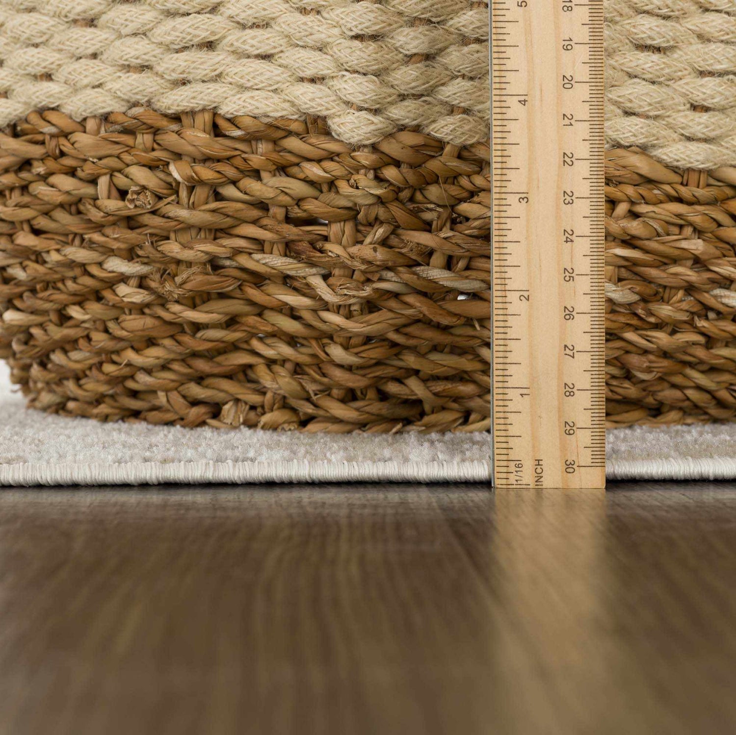 Close-up of Tupsan Washable Area Rug showing the cream color, soft texture, and rug thickness with a ruler. Pile