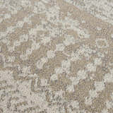 Close-up of the Tupsan Washable Area Rug showing its cream, light beige, and light gray abstract pattern. Texture
