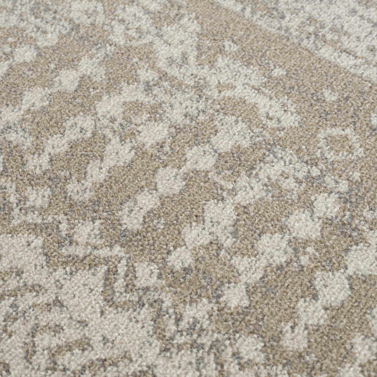 Close-up of the Tupsan Washable Area Rug showing its cream, light beige, and light gray abstract pattern. Texture