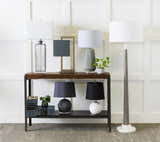 Console table styled on Angie Area Rug in charcoal with striped pattern. Lamps, books, and plants decorate the scene. Styleshot