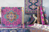 Franktown Magenta Carpet display. Bohemian style rugs in aqua, blue, fuchsia, ivory, and orange colors. Styleshot
