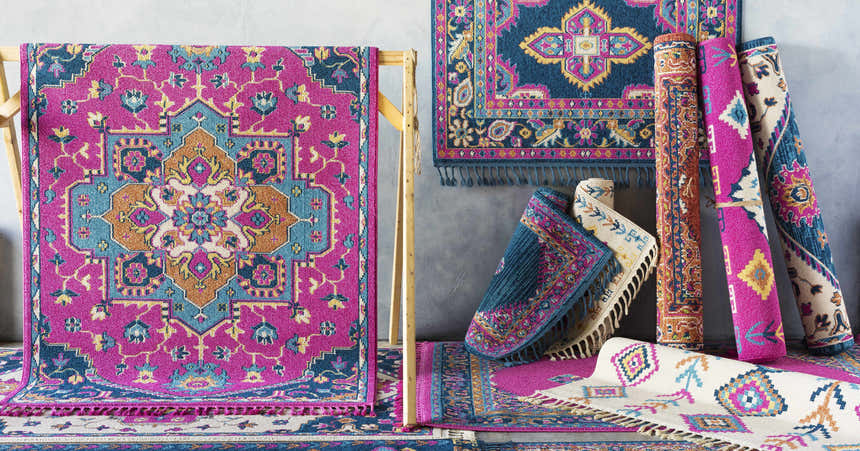 Franktown Magenta Carpet clearance: Colorful bohemian rug with fuchsia, blue, and camel medallion pattern. Rolled rugs shown. Styleshot