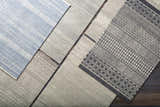 Close-up of assorted rugs, including the Lone Beige Tufted Maroc Wool Rug, showing geometric patterns and textures. Styleshot
