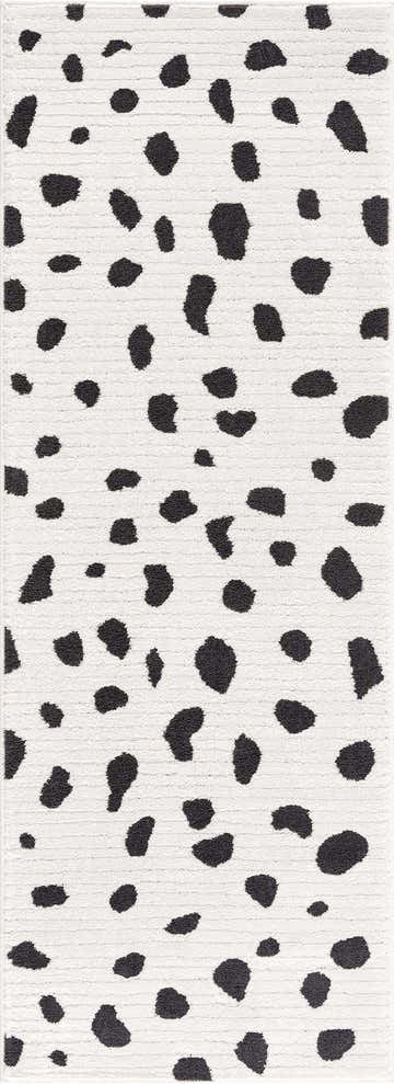Close-up of the Tariffville Dalmatian Rug. Black spots on an off-white shag rug. Fun animal print. Design-Runner-2773