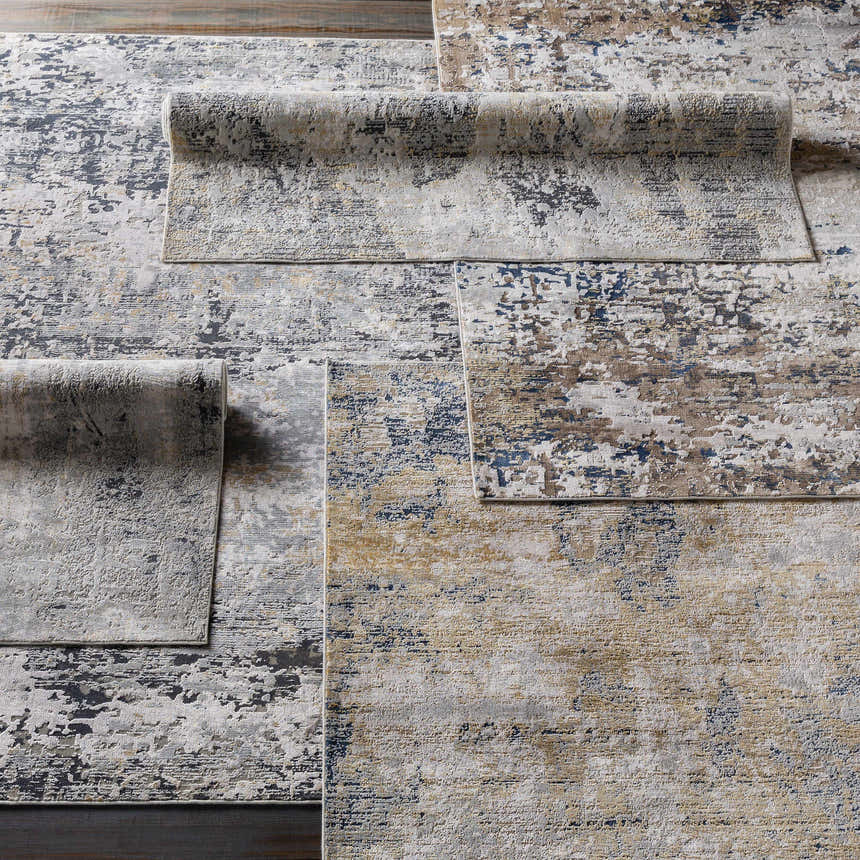 Close-up of the Hayle Area Rug showcasing its charcoal, gray, mustard, and off-white contemporary abstract design. Styleshot