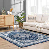 Living room scene with a blue and white Billy Area Rug, beige sofa, and wood cabinet. Roomscene-Rectangle