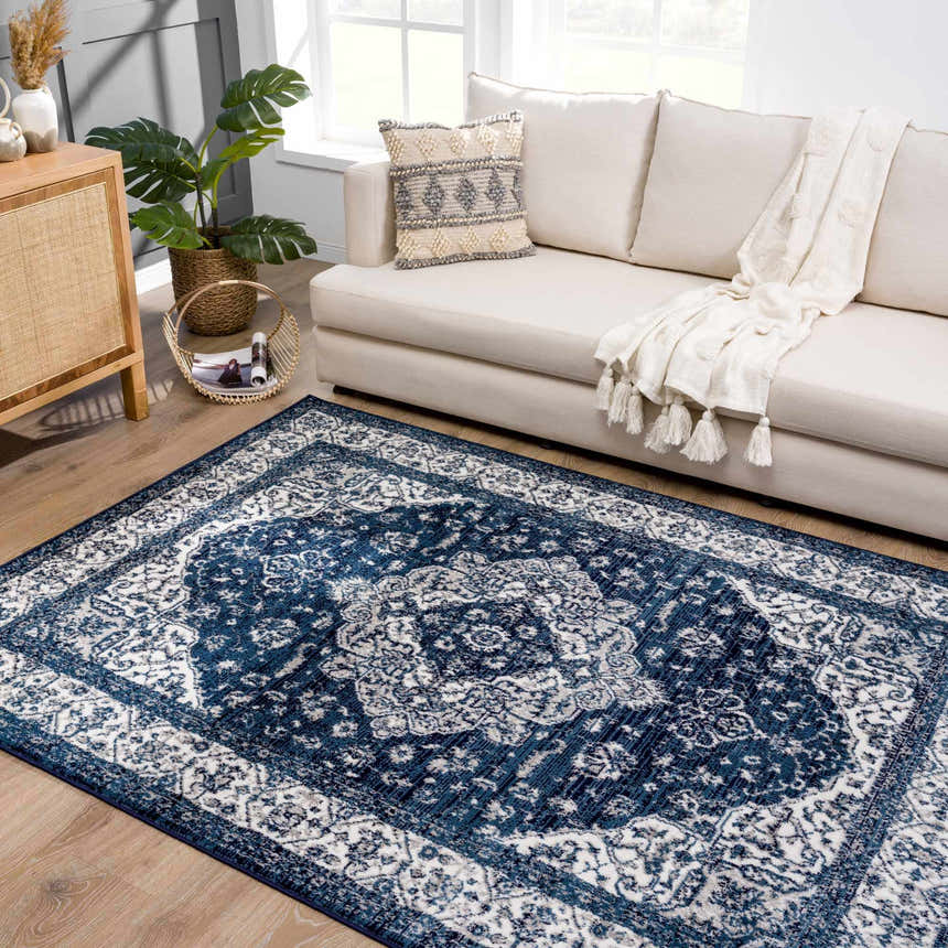 Living room scene with a blue Oriental Billy Area Rug, a cream sofa, and natural wood accents. Roomscene-Rectangle