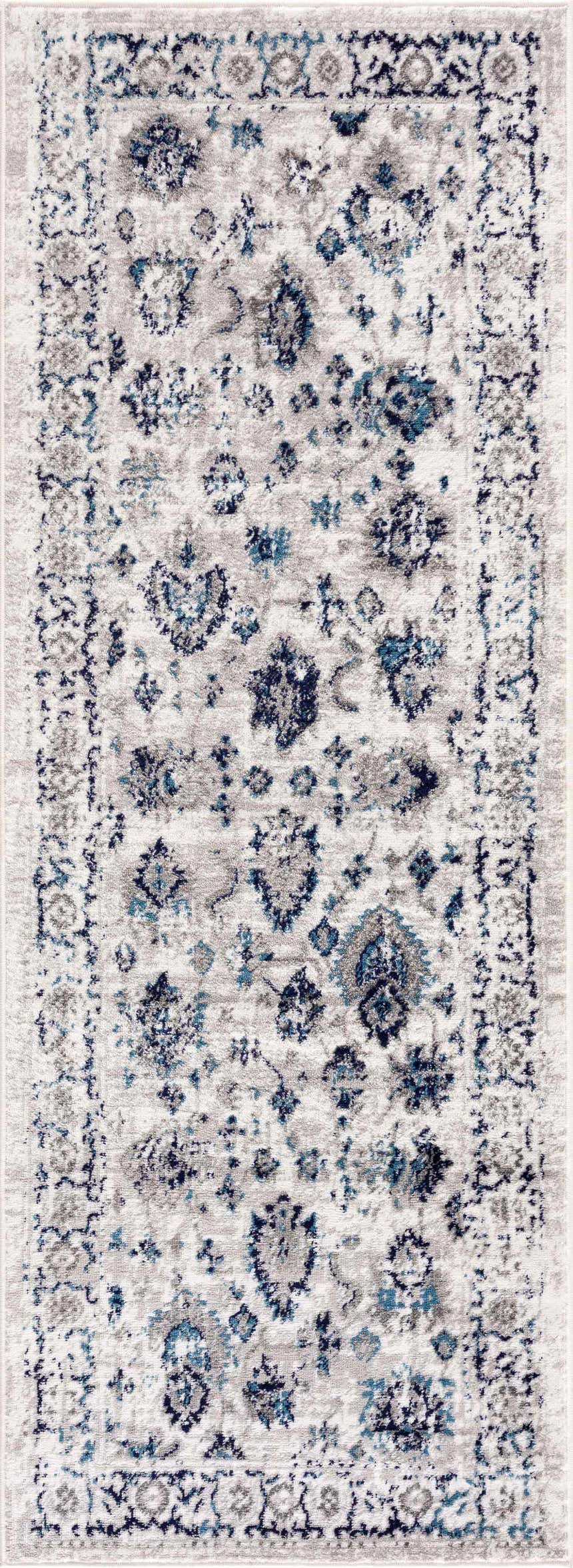 Close-up of the Duena Area Rug. Blue and light gray traditional vintage pattern, machine woven polypropylene. Design-Runner
