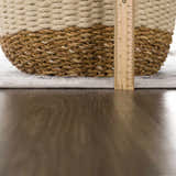 Close-up of the Duena Area Rug showing its light gray and blue traditional pattern with a ruler for scale. Pile
