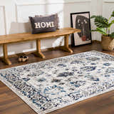 Entryway with wood bench, plant, and blue and light gray Duena Area Rug. Roomscene-Rectangle